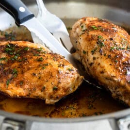 Blacked chicken in a skillet.