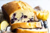 Slices of blueberry lemon yogurt cake on a baking rack.