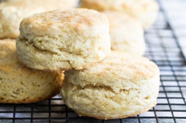 Buttermilk biscuits on a baking rack.