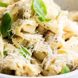 A bowl of cheese tortellini in garlic butter.