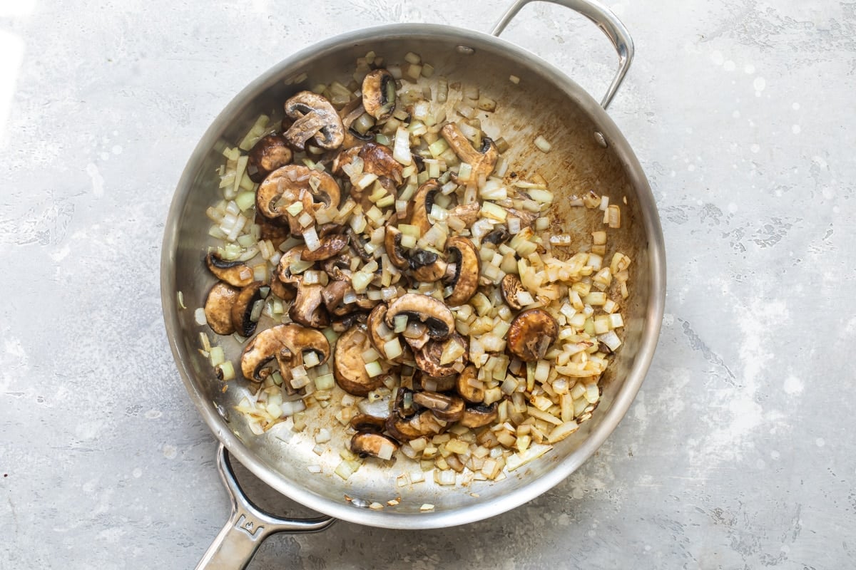 Chicken and mushroom stroganoff sauce cooking in a skillet.