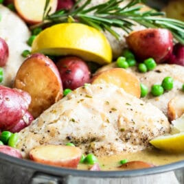 Chicken vesuvio in a silver skillet.
