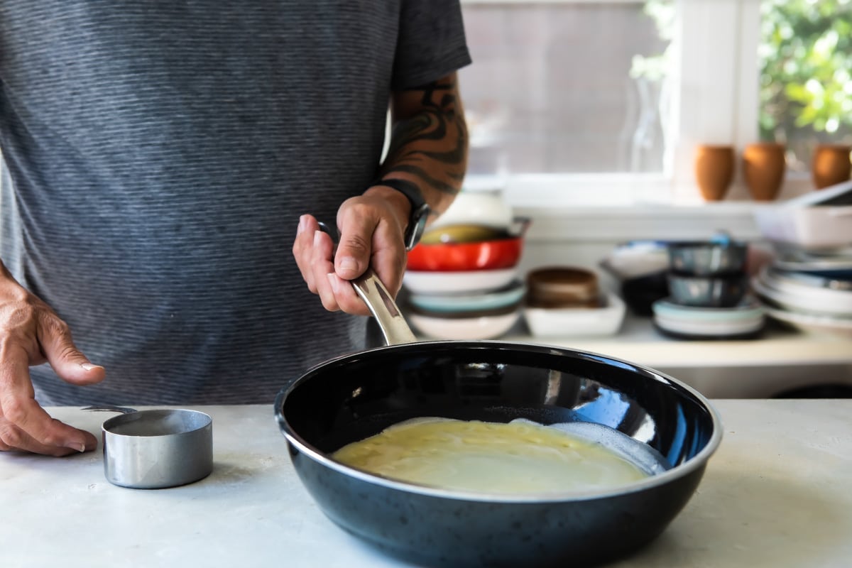 Cooking crepes in a pan.