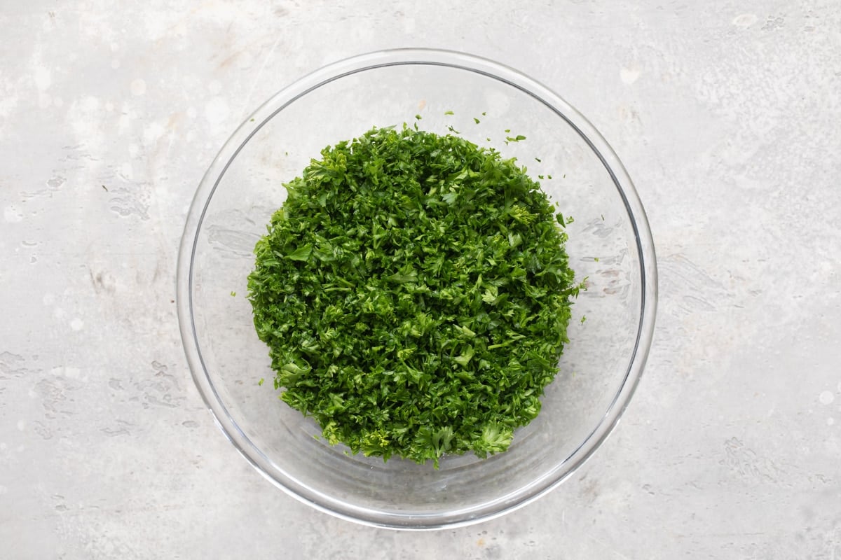 Curly parsley in a clear bowl.