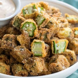Fried okra pieces in a white bowl.