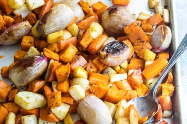 Roasted root vegetables on a baking sheet.
