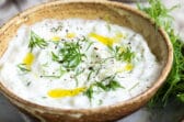 Tzatziki Sauce in a small brown bowl.