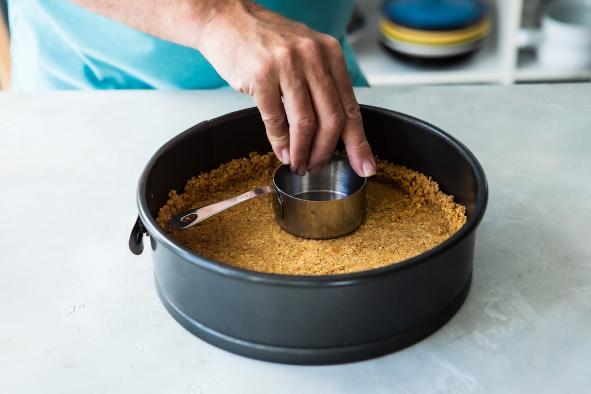 A graham cracker crust in a springform pan.