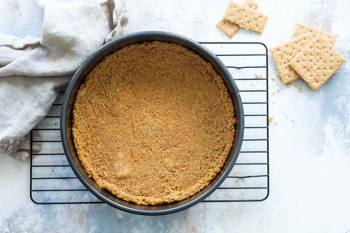 A graham cracker crust in a springform pan.