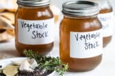 Labeled vegetable stock in mason jars.