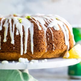 A 7up cake on a marble cake stand.