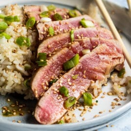 Ahi tuna on a plate with brown rice.