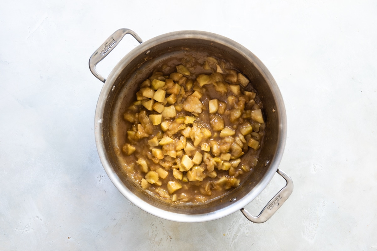Apple pie filling in a silver pot.