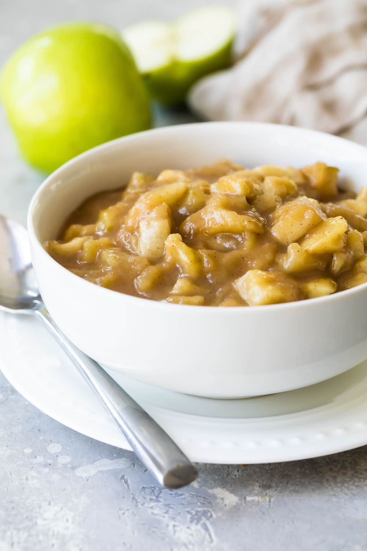 Apple pie filling in a white bowl.