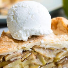 Apple pie a la Mode on a gray plate.