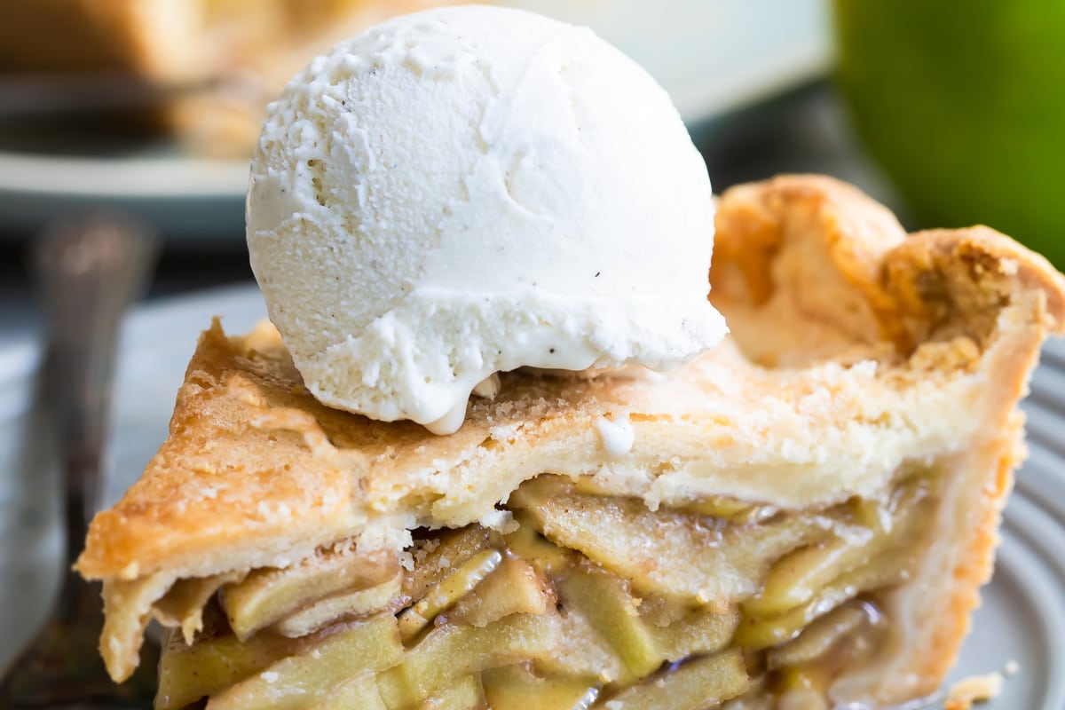 Apple pie a la Mode on a gray plate.