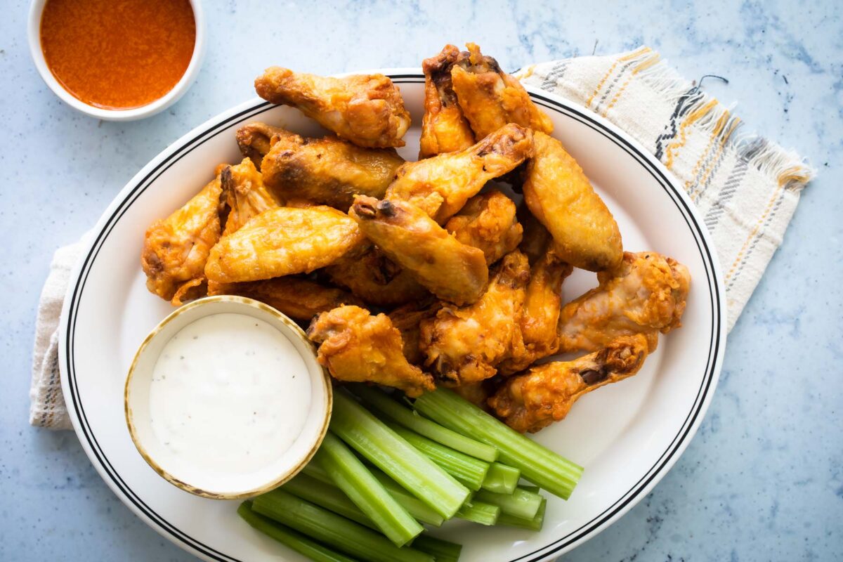 Baked buffalo chicken wings on a platter.