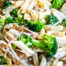 Cajun chicken alfredo with broccoli in a silver skillet.