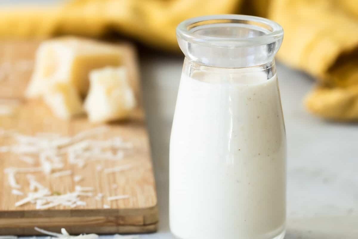 Caesar salad dressing in a clear bottle.