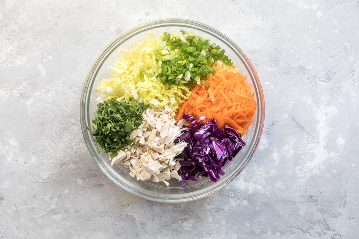 A bowl of Chinese chicken salad with Asian salad dressing.