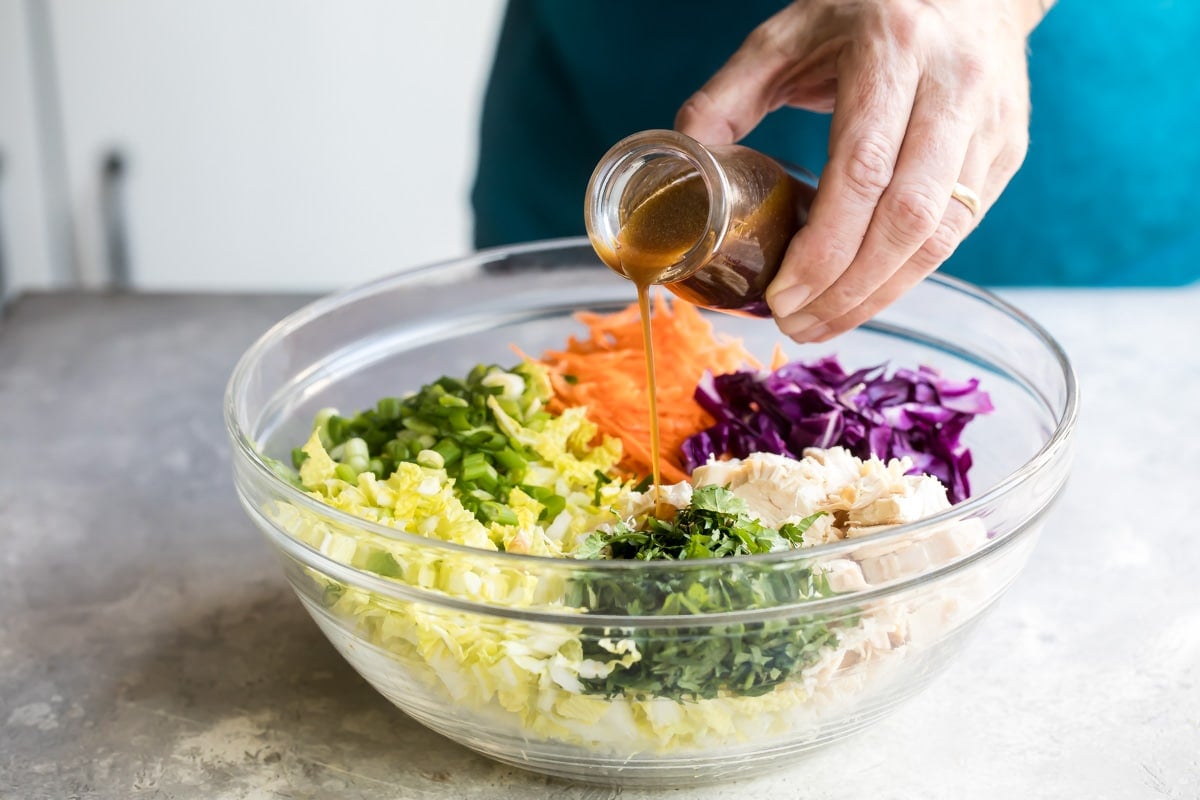 A bowl of Chinese chicken salad with Asian salad dressing.