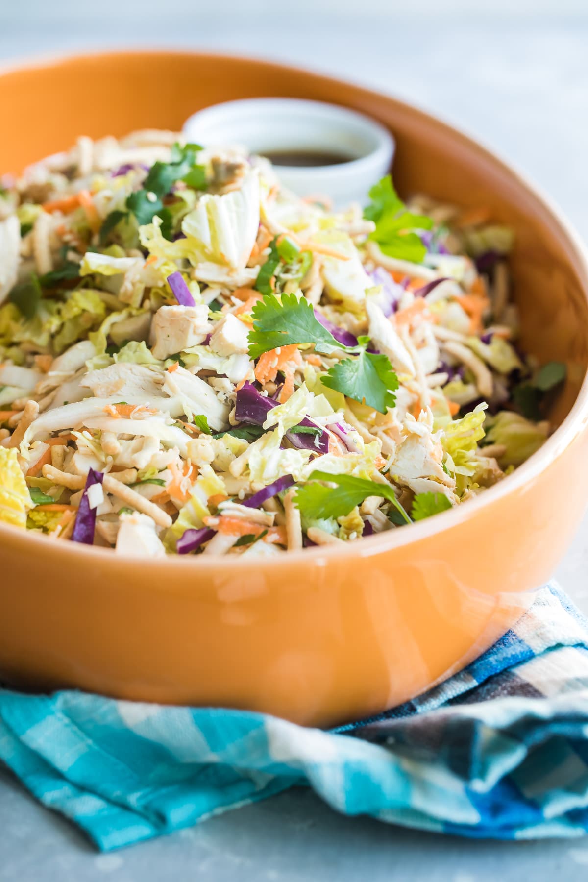 A bowl of Chinese chicken salad with Asian salad dressing.