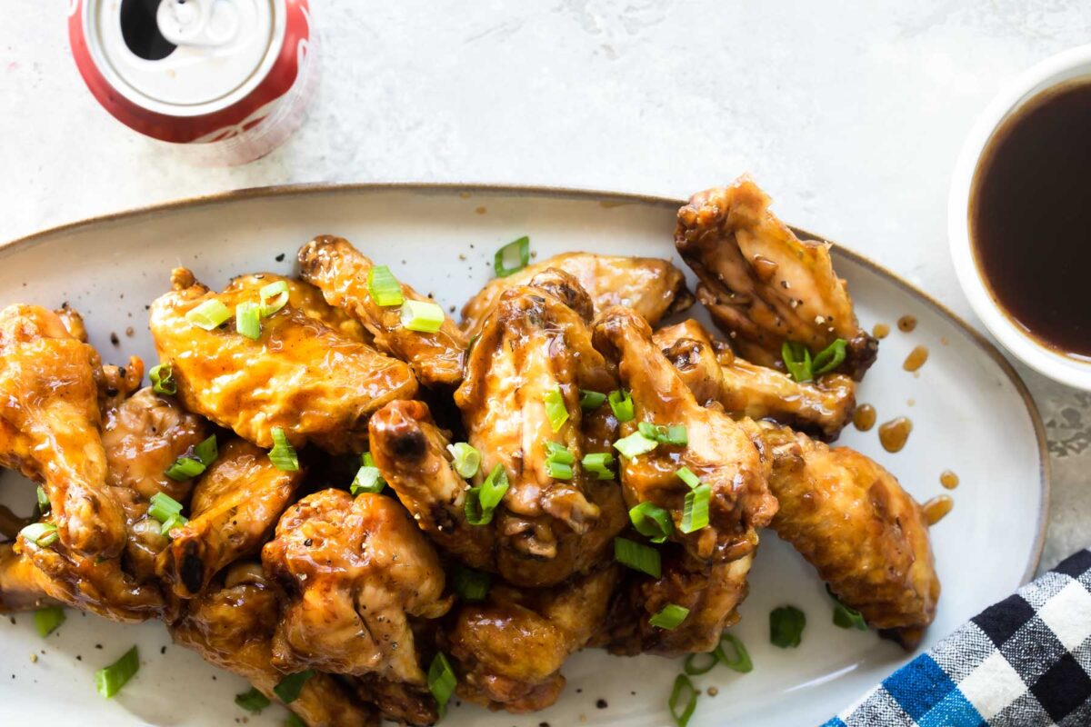 Coca Cola chicken wings on a white platter.