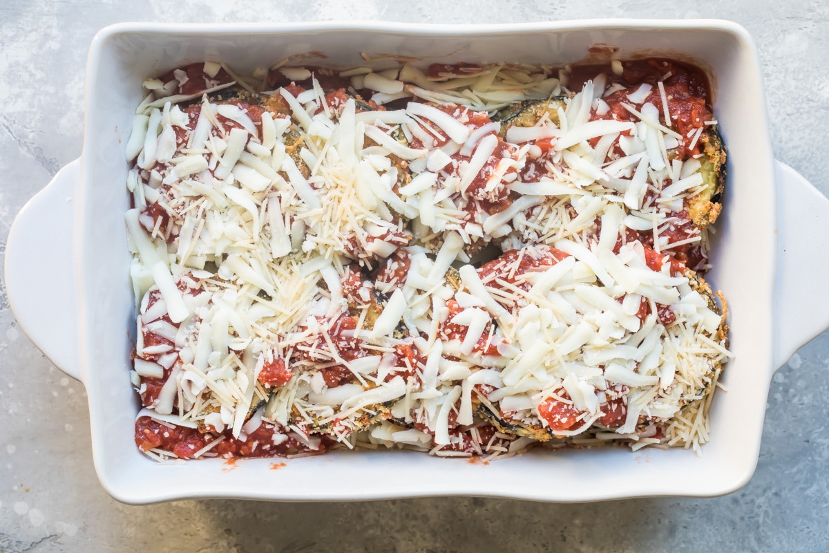 Eggplant parmesan in a white baking dish.
