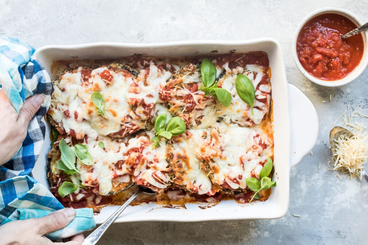 Eggplant parmesan in a white baking dish.