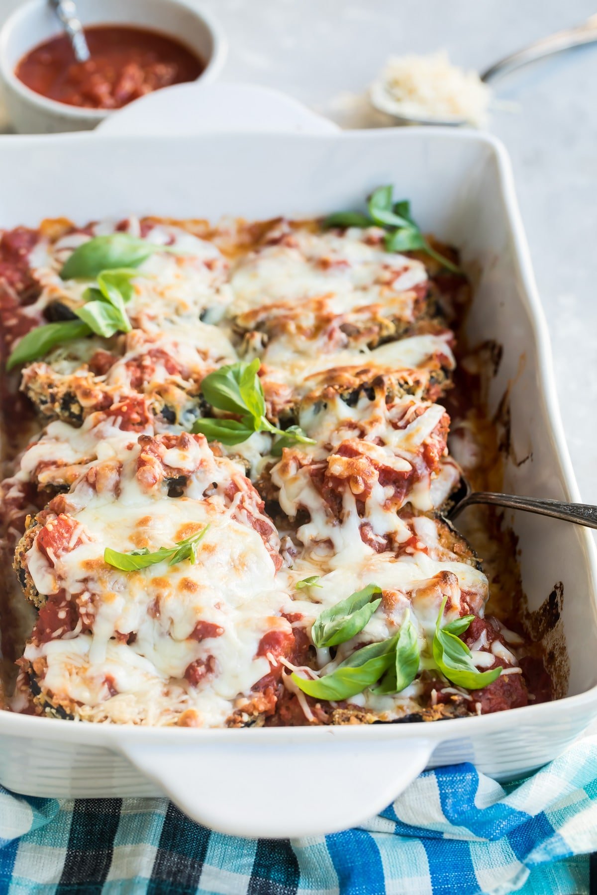 Eggplant parmesan in a white baking dish.