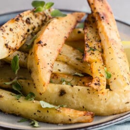 Greek roasted potatoes on a gray plate.