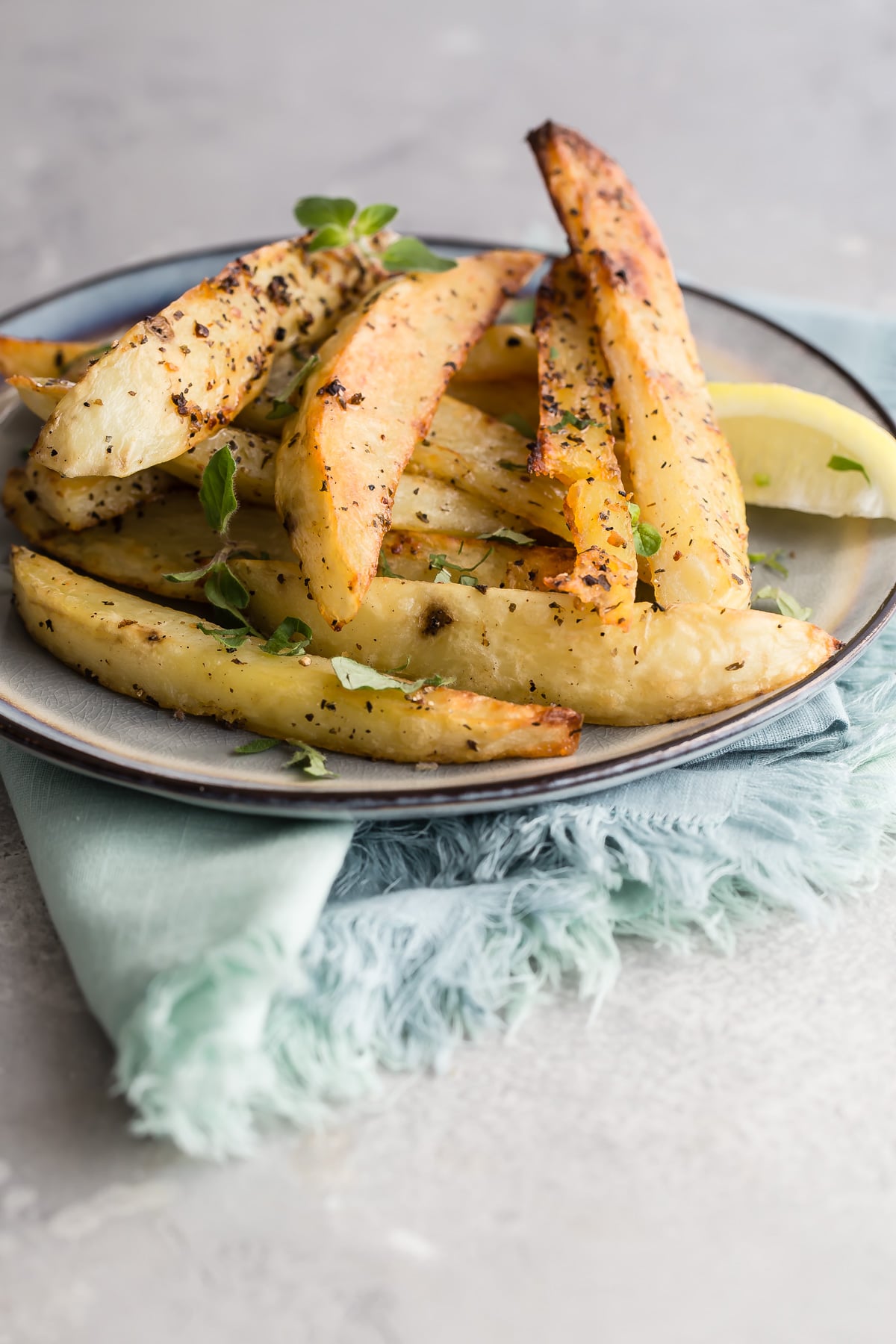 Greek roasted potatoes on a blue plate.