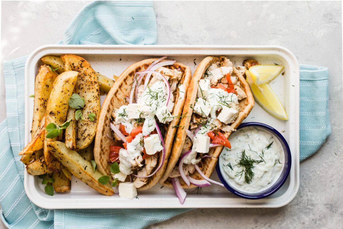 Chicken gyros and Greek roasted potatoes on a serving platter.