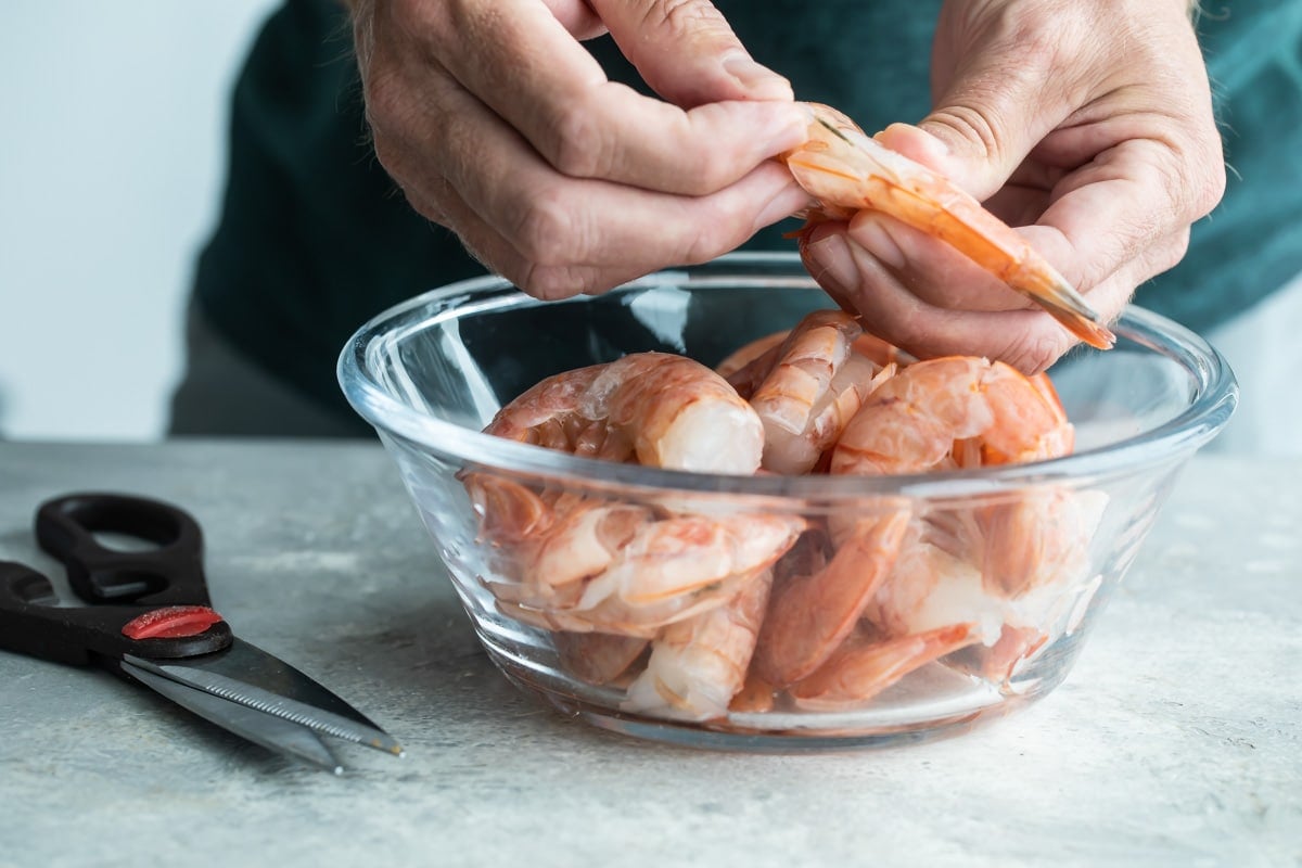 Removing the vein from the back of a shrimp.