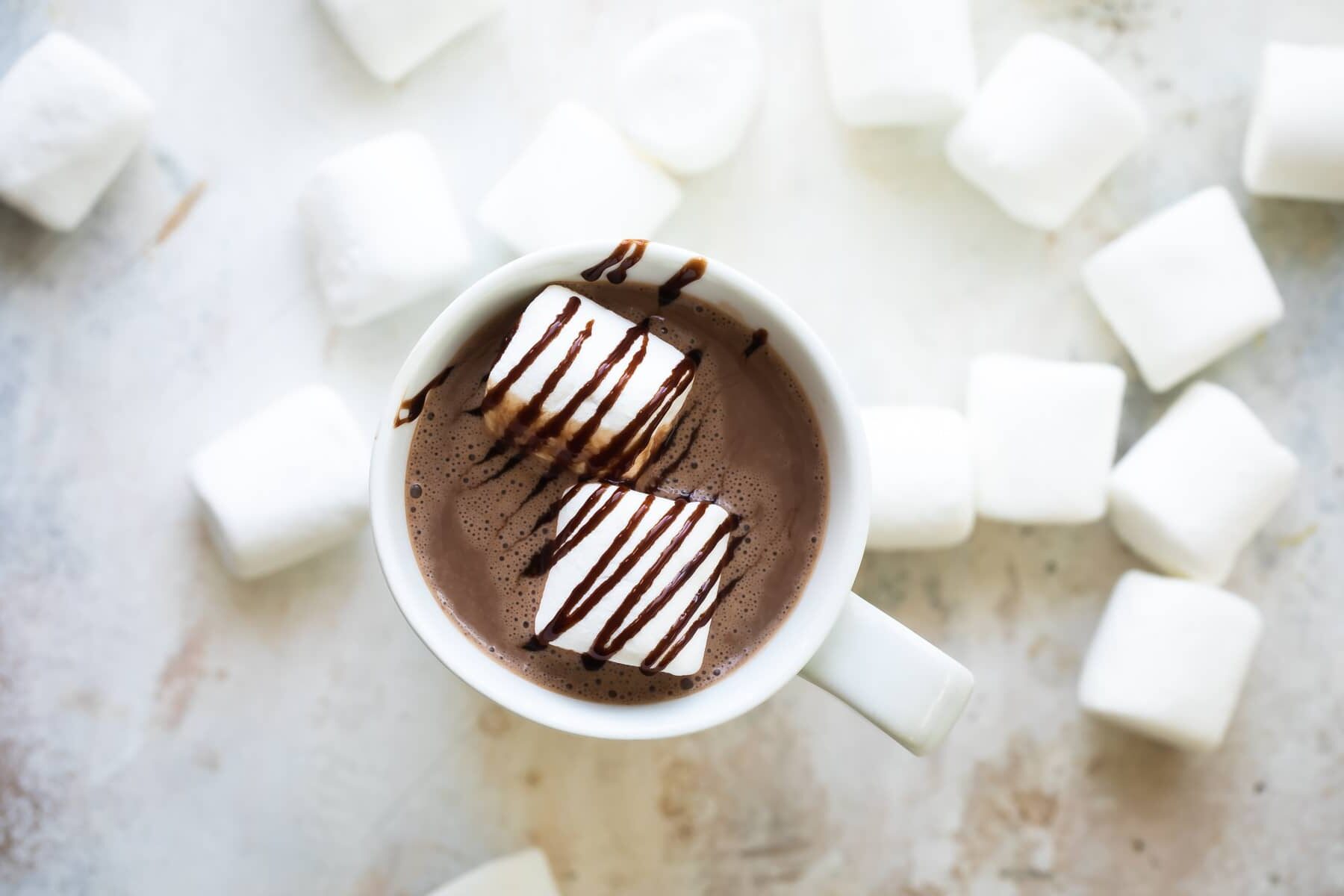 Hot chocolate with two marshmallows in it.