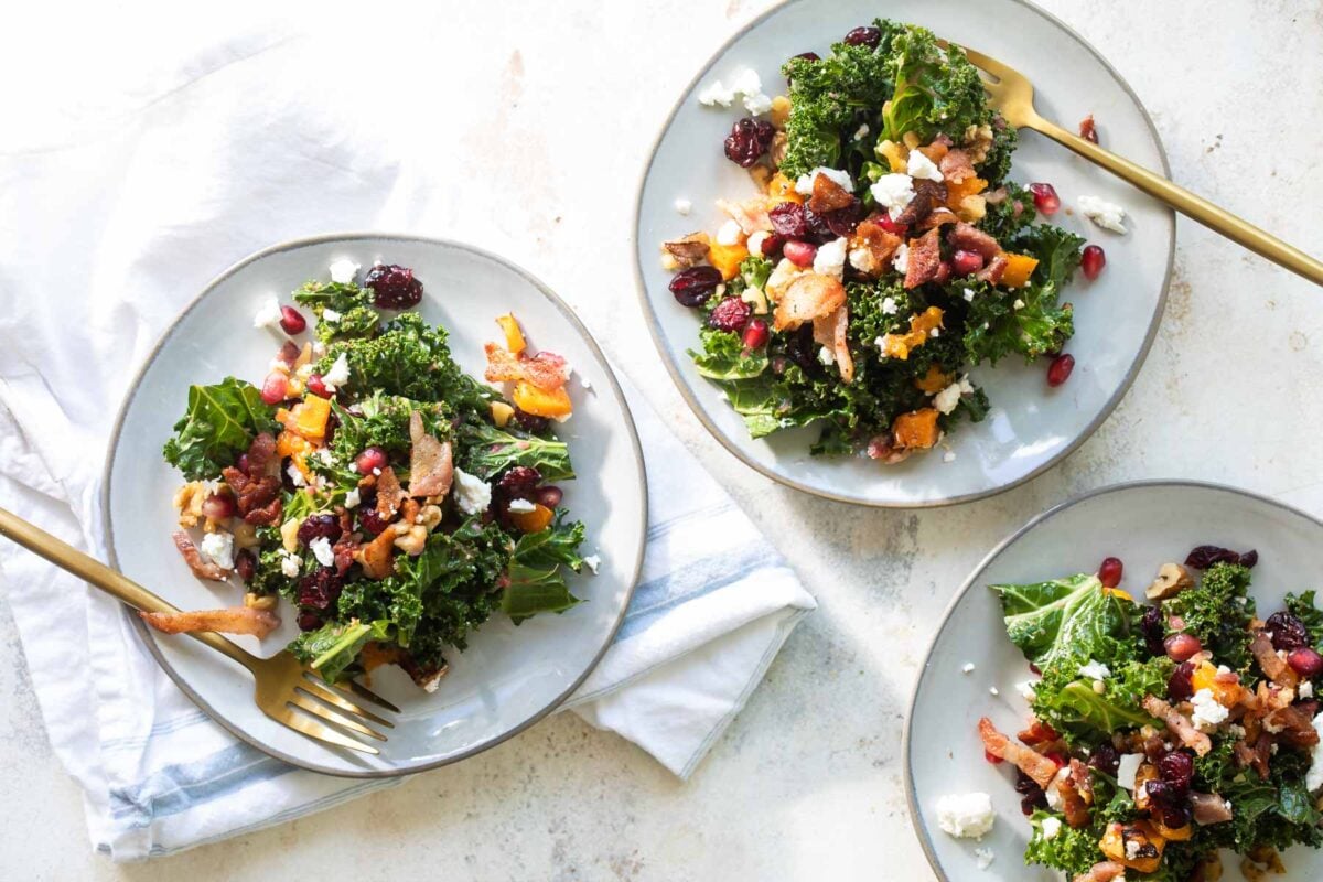 Kale salad on three plates.