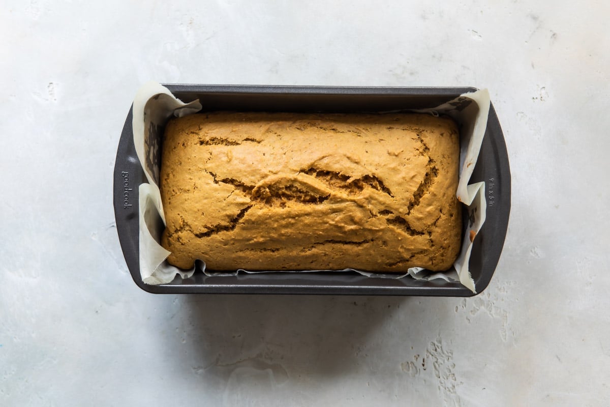 A lemon olive oil cake in a pan.