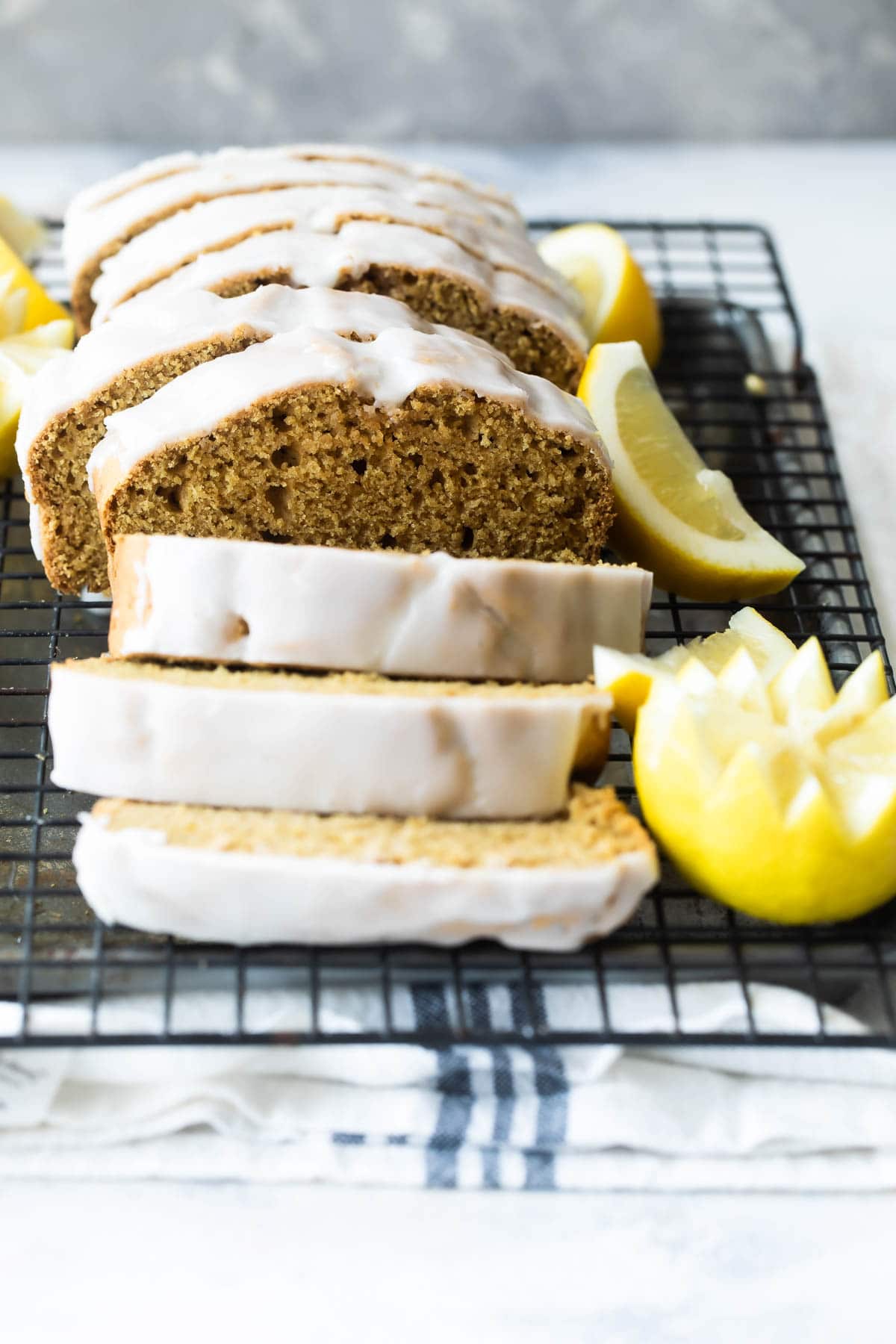 Slices of lemon olive oil cake on a cooling rack.