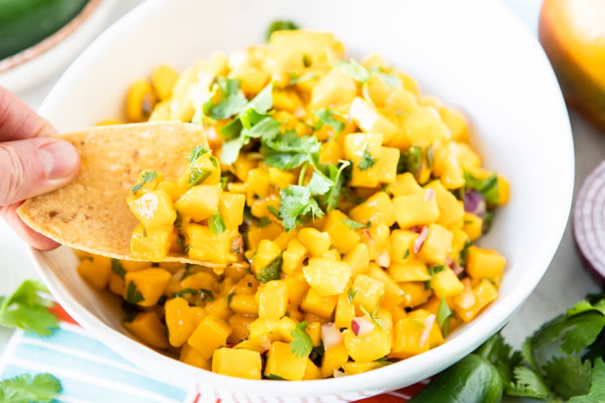 Mango salsa in a white bowl.