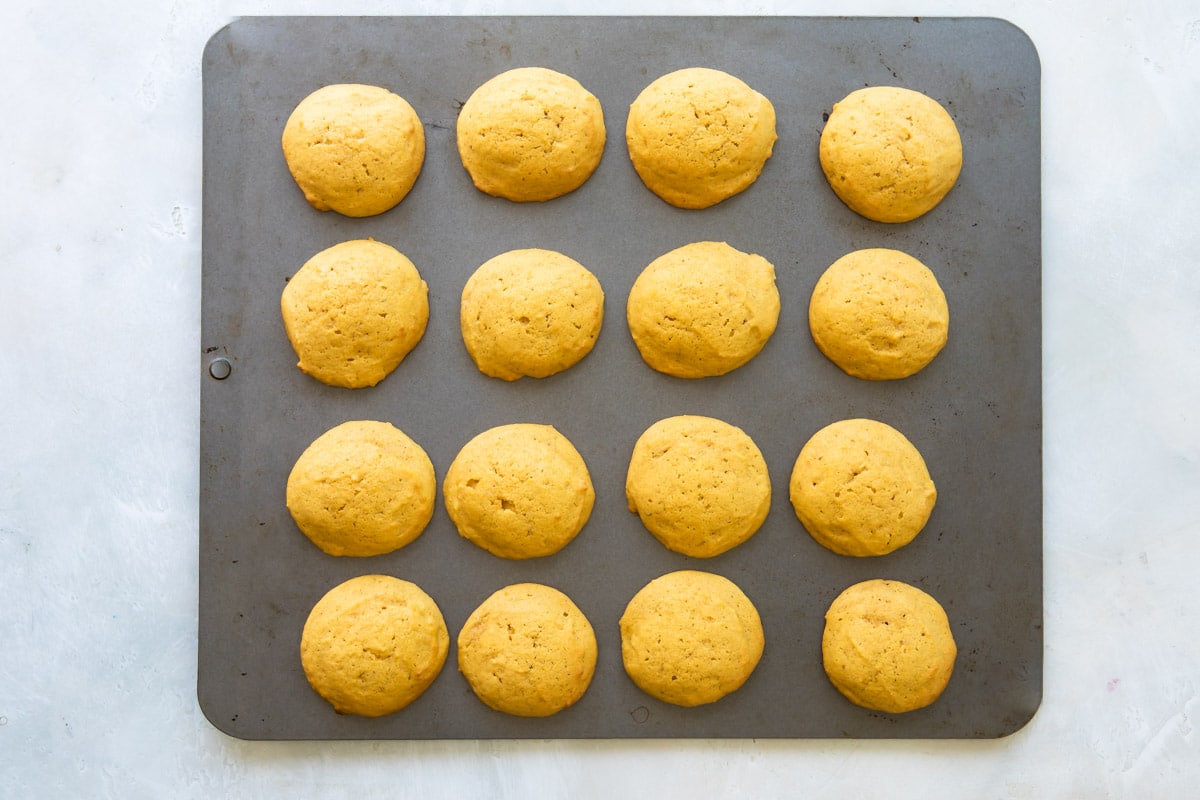 Pumpkin cookies on a baking sheet.