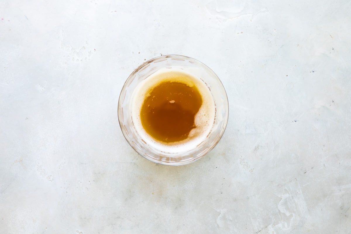 Melted butter in a clear bowl.