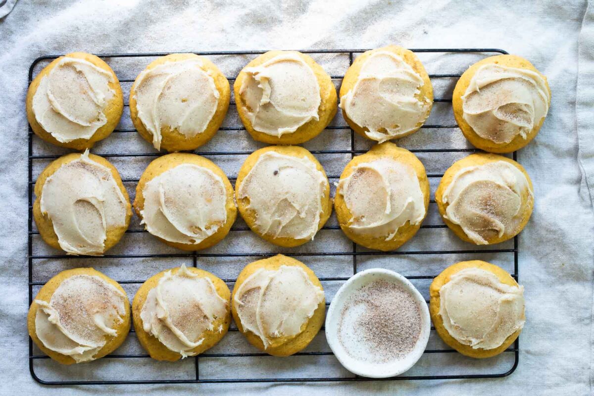 Pumpkin cookies on a cooling rack.