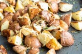 Roasted rosemary potatoes on a baking sheet.