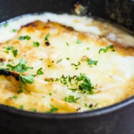 Saganaki in a black cast iron skillet.