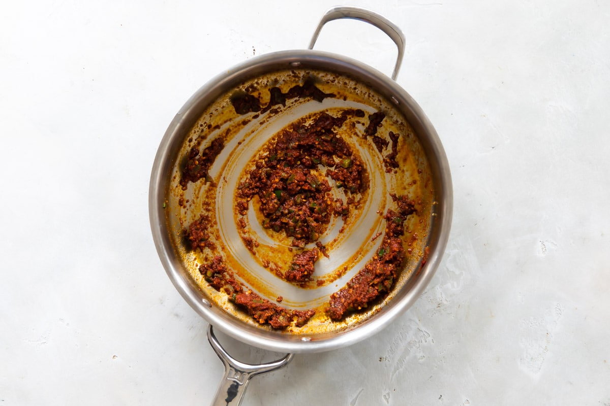 Shakshouka seasonings in a silver skillet.