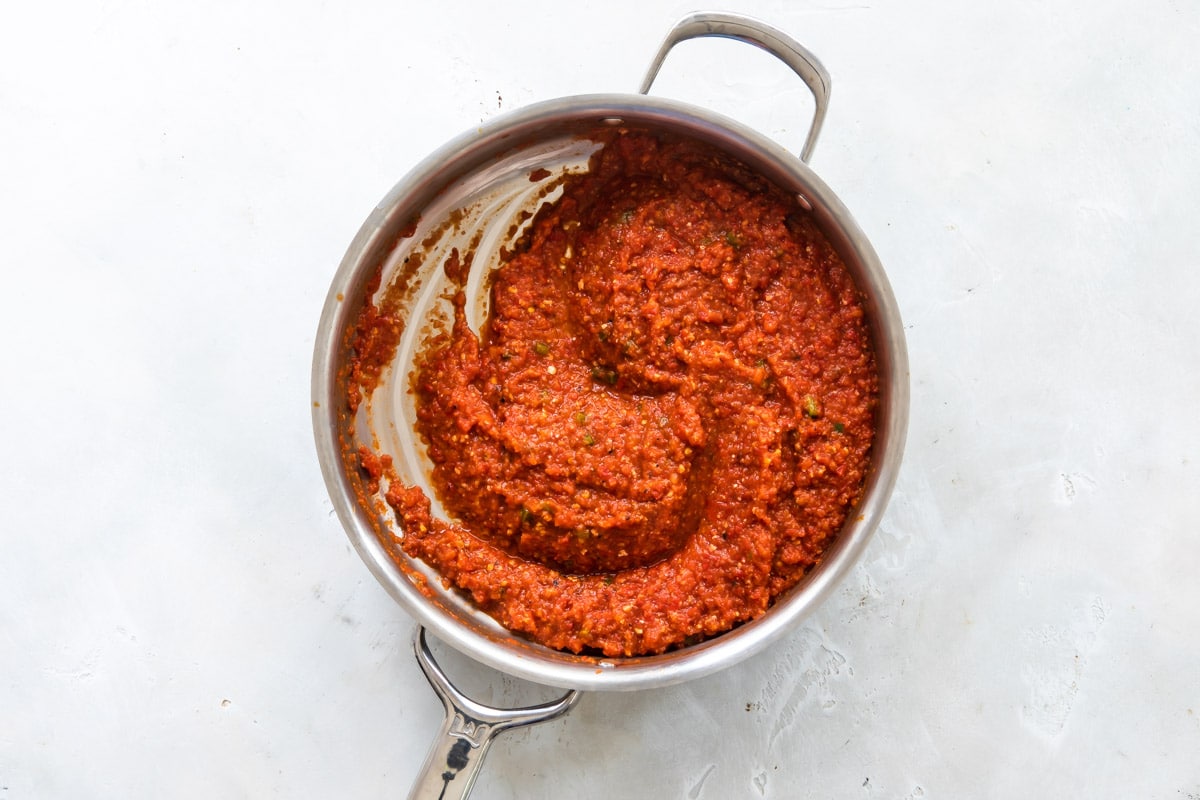 Shakshouka before being cooked in a silver skillet.