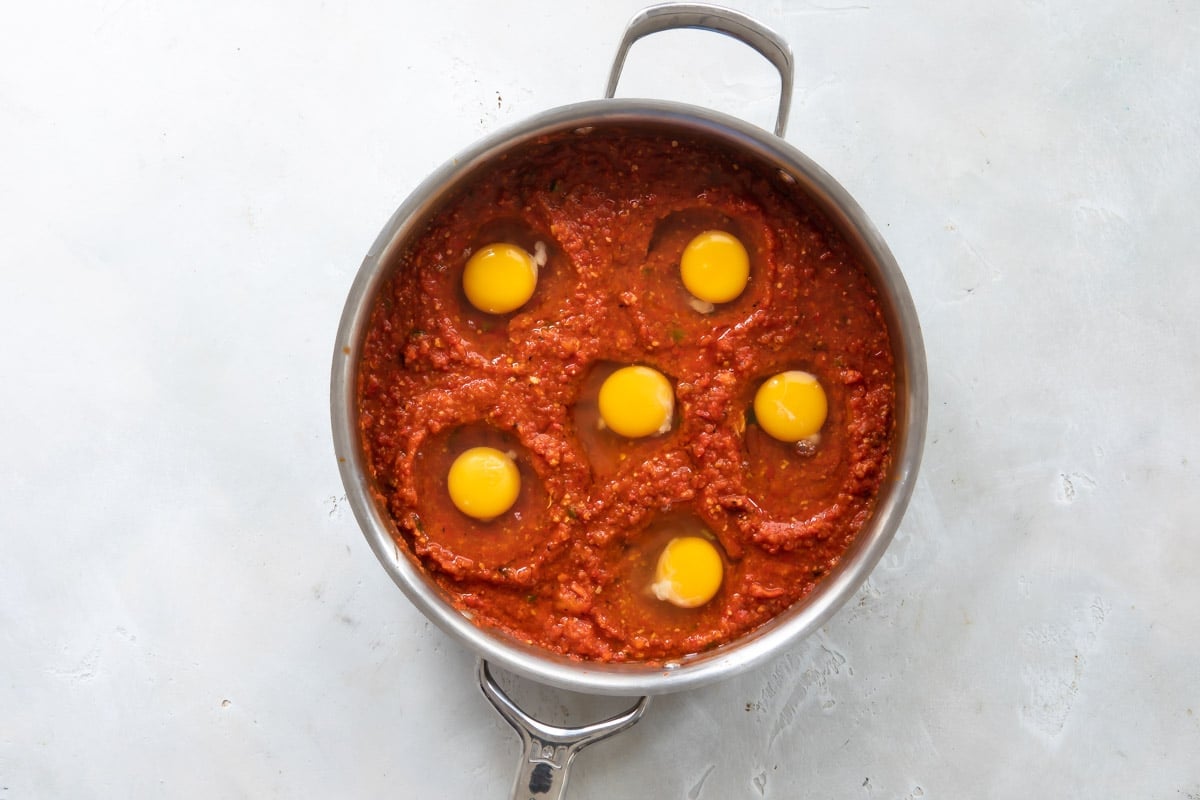 Shakshouka before being cooked in a silver skillet.