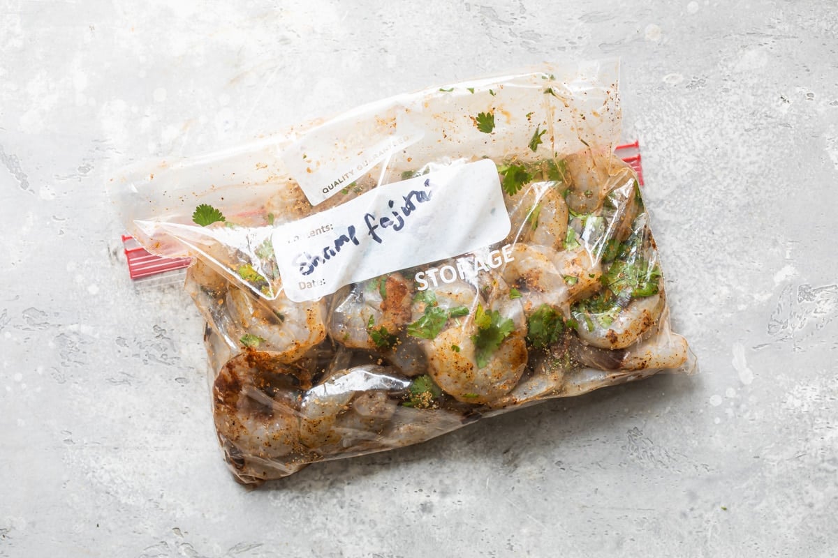 Shrimp being marinated in a Ziploc bag.
