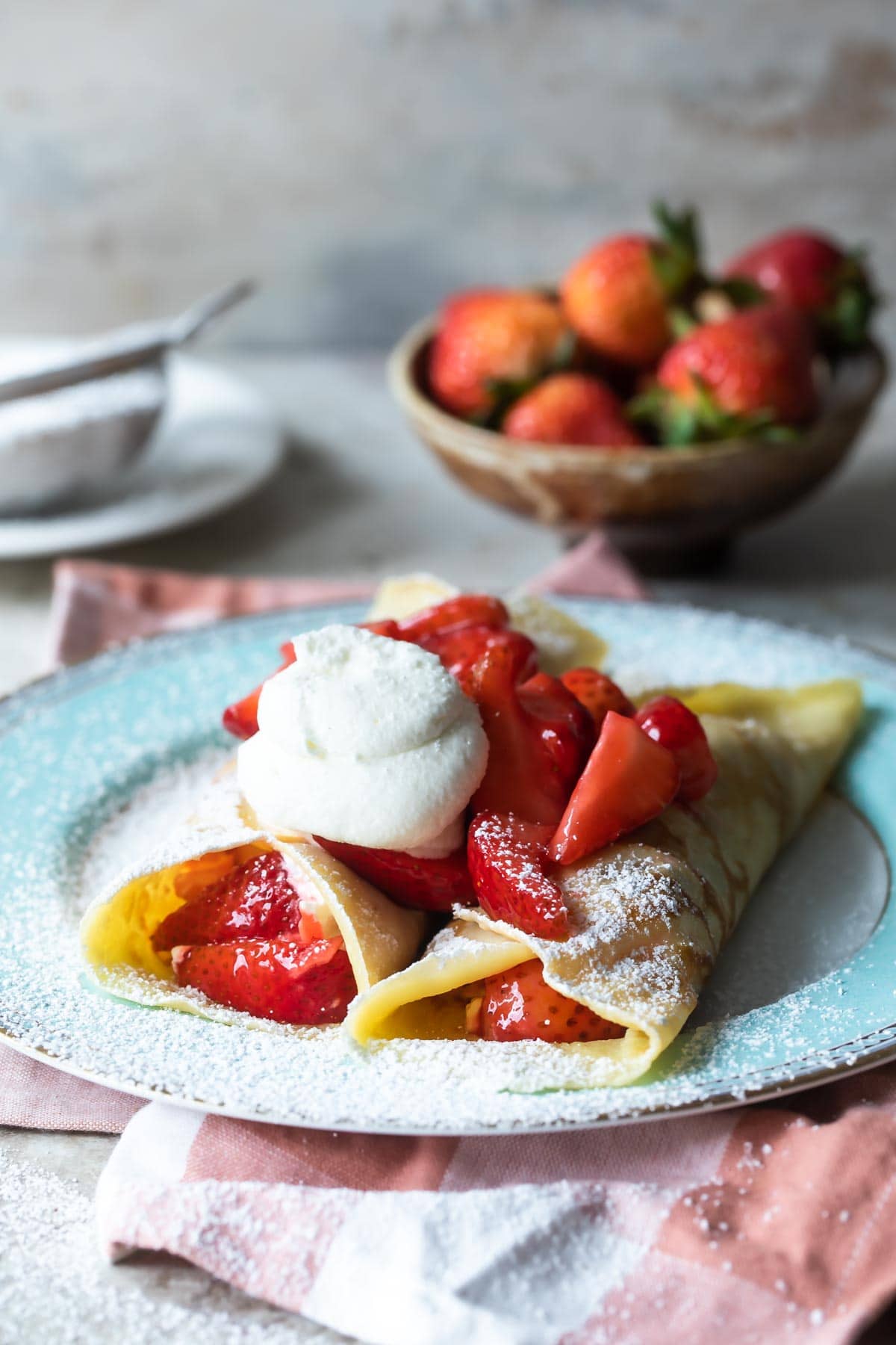 Strawberry crepes on a plate.