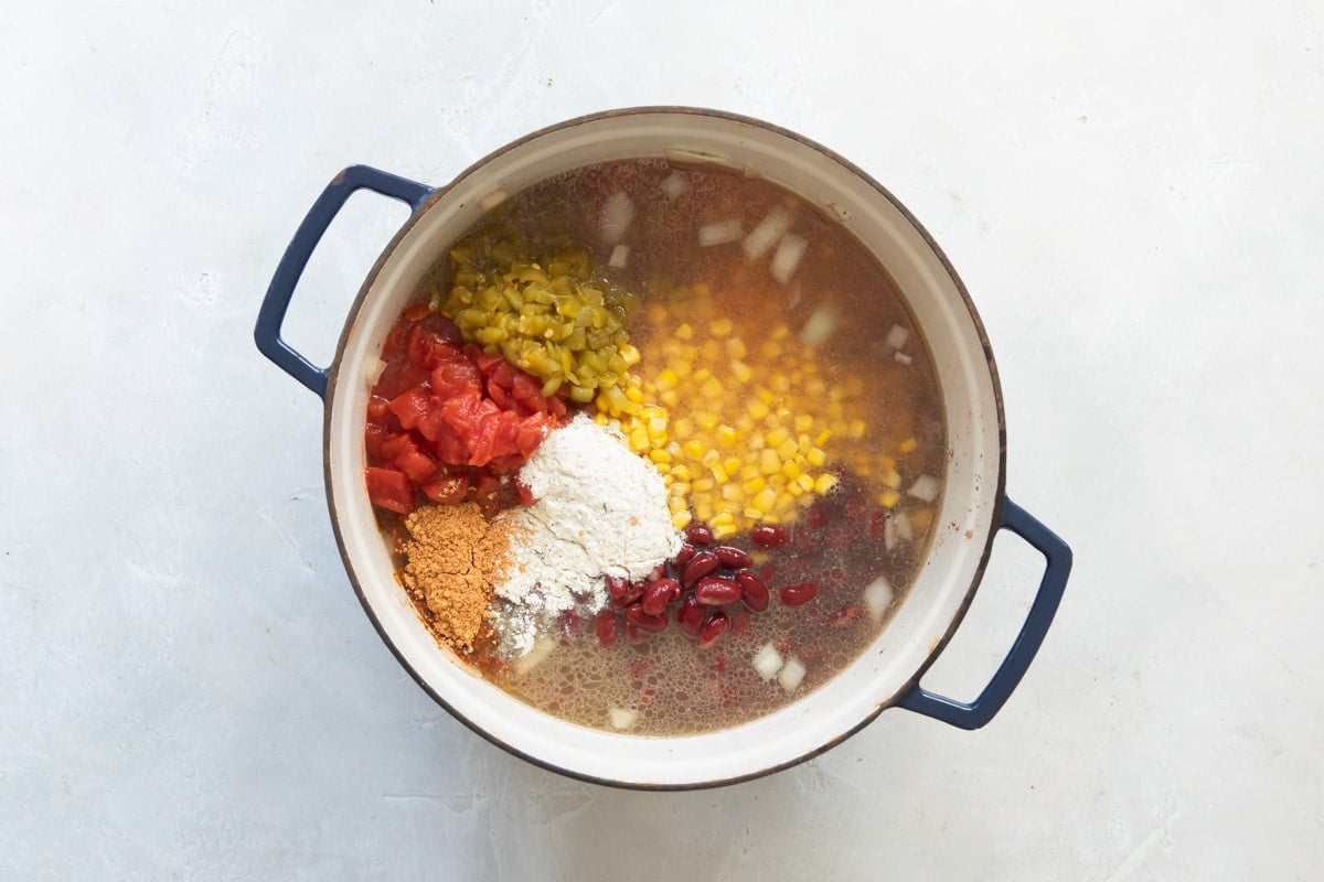 Taco soup ingredients in Dutch oven.